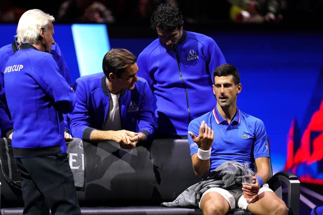 Novak Djokovic speaks with captain Bjorn Borg, Roger Federer (second left) and Matteo Berrettini