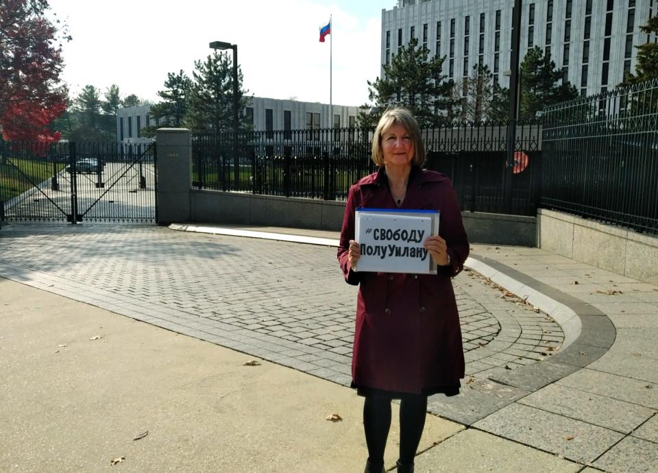 Elizabeth Whelan holds up a sign that says #FreePaulWhelan in Cyrllic in front of the Russian embassy in Washington, D.C. She's the sister of Paul Whelan, the Michigan man who is accused of spying in Russia.