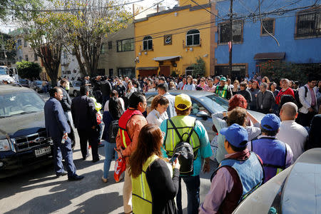 People stand at a street following an earthquake in Mexico City, Mexico February 1, 2019. REUTERS/Carlos Jasso