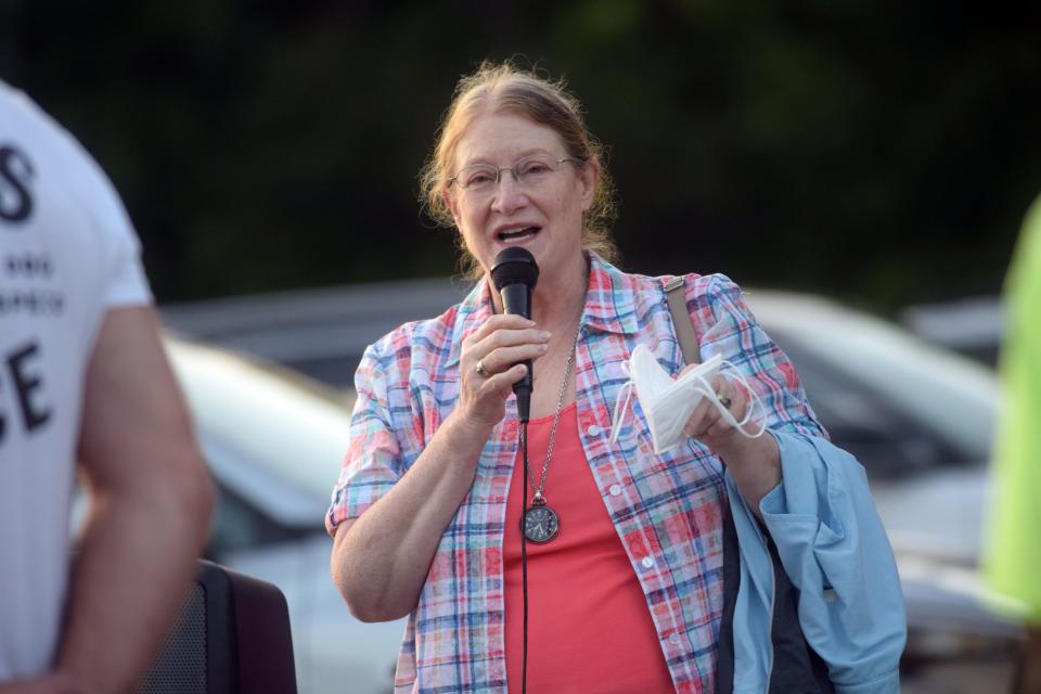 Jo Ellen Rudolph, a Hayes Township resident, speaks to a crowd of about 60 people outside the township hall at 9195 Major Douglas Sloan Road on Tuesday, Sept. 20.