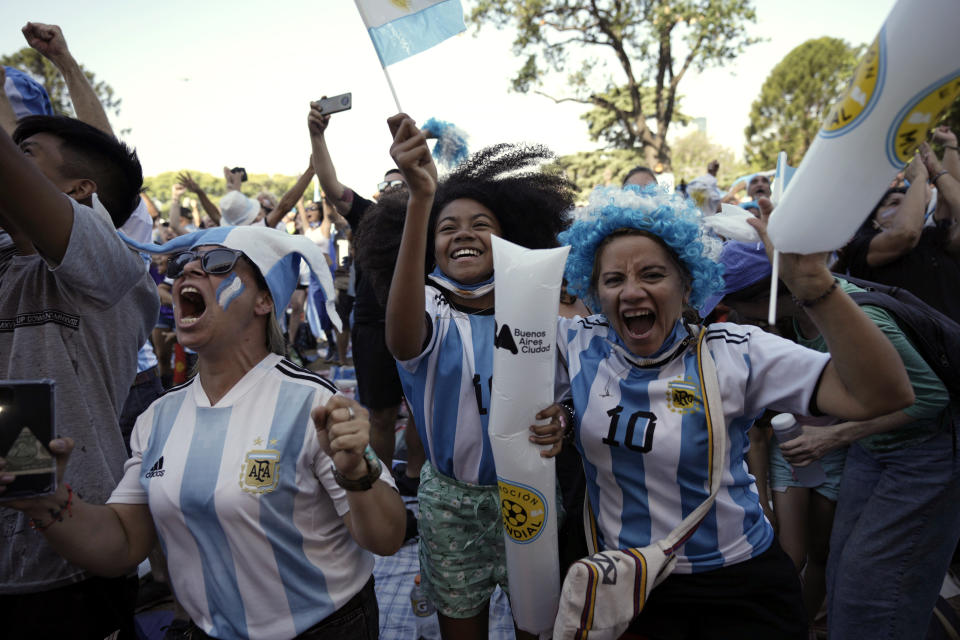 Argentina soccer fans celebrate a goal as they watch their team's World Cup semifinal match against Croatia, hosted by Qatar, on a screen set up in the Palermo neighborhood of Buenos Aires, Argentina, Tuesday, Dec. 13, 2022. (AP Photo/Rodrigo Abd)