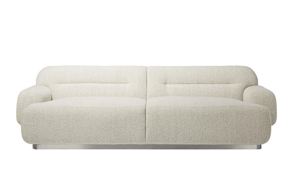 This undated photo shows CB2's Logan sofa. Designer John McClain, whose studio is in Orlando, says one big trend he's seeing in fall décor is a range of deep, cozy textures like boucle and shearling. "(They're) are cropping up on more than just pillows these days – entire sofas, chairs and headboards are sporting luscious upholstery reminiscent of lambs, puppies and ponies." CB2 has several options, including the Gwyneth side chair, Logan sofa and Azalea chair. (CB2 via AP)