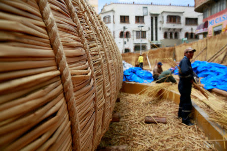 Aymara builders work on the 'Viracocha III', a boat made only from the totora reed, as it is being prepared to cross the Pacific from Chile to Australia on an expected six-month journey, in La Paz, Bolivia, October 19, 2016. REUTERS/David Mercado