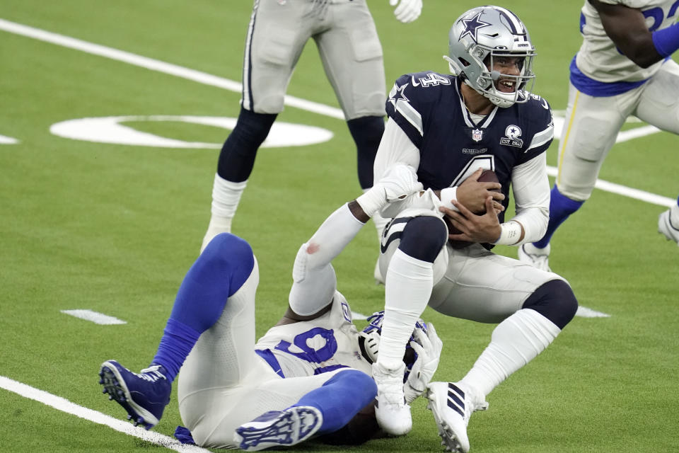 Dallas Cowboys quarterback Dak Prescott, right, is tackled by Los Angeles Rams defensive end Michael Brockers. (AP Photo/Jae C. Hong )