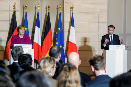 French President Emmanuel Macron and German Chancellor Angela Merkel attend a joint news conference before a meeting at the Elysee Palace in Paris, France, January 19, 2018. REUTERS/Christophe Petit Tesson/Pool