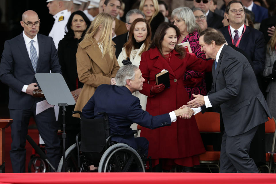 Texas Gov. Greg Abbott, front left, is congratulated by family and friends after his inauguration ceremony, in Austin, Texas, Tuesday, Jan. 15, 2019. Abbott has made no mention of President Donald Trump's proposed border wall after taking the oath for a second term as Texas governor. (AP Photo/Eric Gay)