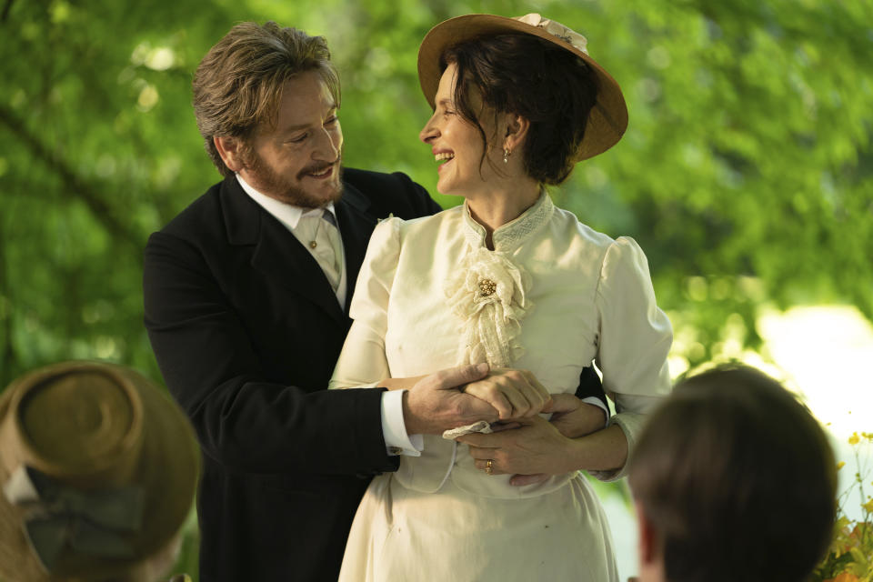 This image released by IFC Films shows Juliette Binoche, right, and Benoît Magimel in a scene from "The Taste of Things." (Stéphanie Branchu/IFC Films via AP)