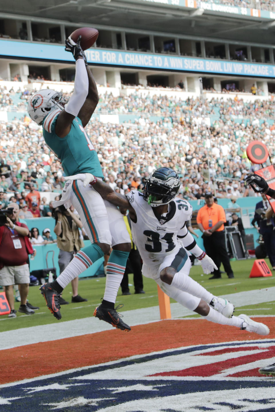 Miami Dolphins wide receiver DeVante Parker (11) catches a pass for a touchdown as Philadelphia Eagles cornerback Jalen Mills (31) defends, during the second half at an NFL football game, Sunday, Dec. 1, 2019, in Miami Gardens, Fla. (AP Photo/Lynne Sladky)