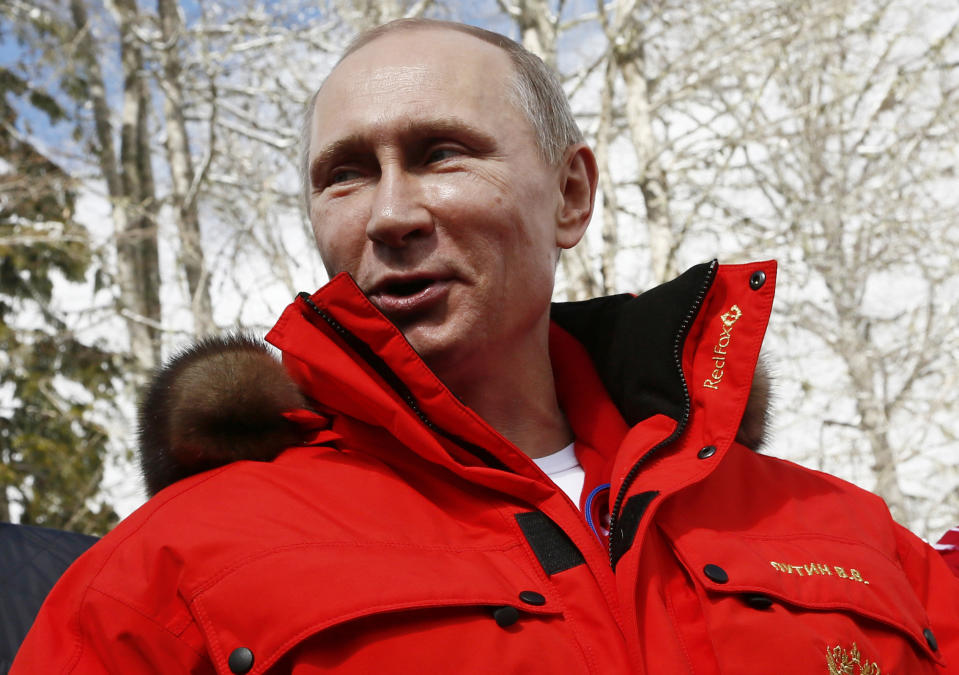 Russian President Vladimir Putin speaks during his meeting with Russian athletes, winners of the cross country 4x2.5km open relay, at the 2014 Winter Paralympic, Saturday, March 15, 2014, in Krasnaya Polyana, Russia. (AP Photo/Dmitry Lovetsky)