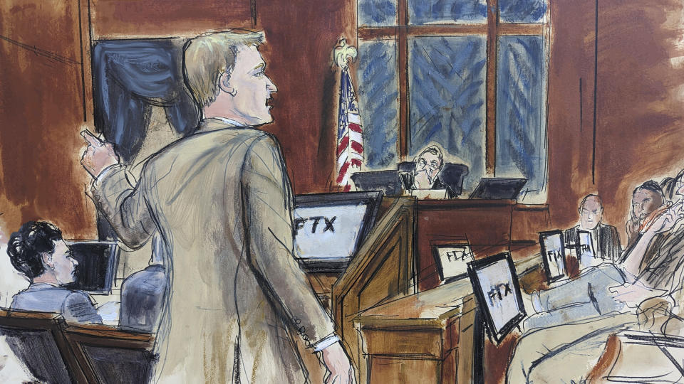 This courtroom sketch shows Assistant US Attorney Thane Rehn as he delivers his opening statement, while pointing at Sam Bankman-Fried, seated left, during his fraud trial, Wednesday, Oct. 4, 2023. (AP Photo/Elizabeth Williams)