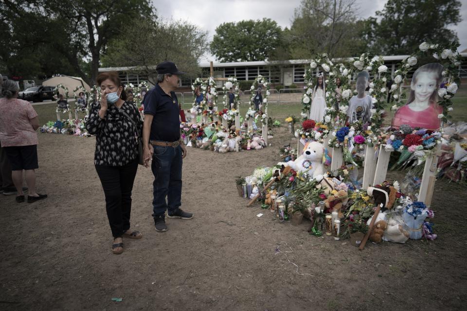 People visit a memorial outside Robb Elementary School in Uvalde, Texas, Monday, May 30, 2022. On May 24, 2022, an 18-year-old entered the school and fatally shot several children and teachers. (AP Photo/Wong Maye-E)