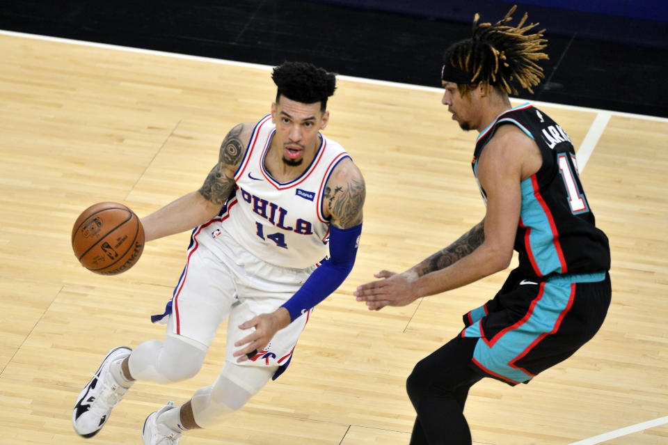 Philadelphia 76ers forward Danny Green (14) drives against Memphis Grizzlies forward Brandon Clarke during the second half of an NBA basketball game Saturday, Jan. 16, 2021, in Memphis, Tenn. (AP Photo/Brandon Dill)