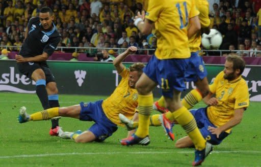 English forward Theo Walcott ( L) shoots to score the equaliser during their Euro 2012 championships match against Sweden at the Olympic Stadium in Kiev on June 15. England won 3-2