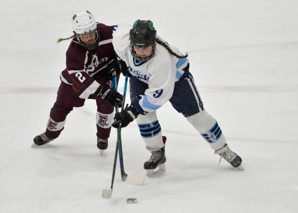 Falmouth's Avery Johnsen, left, and Sandwich's Meghan Barrett go after the puck as they skate down the ice in second period action. Sandwich High School played Falmouth High School in girls hockey action Wednesday at Gallo Ice Arena.
(Photo: Merrily Cassidy/Cape Cod Times)