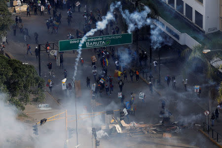 Demonstrators run away during riots at a march to state Ombudsman's office in Caracas, Venezuela May 29, 2017. REUTERS/Carlos Garcia Rawlins