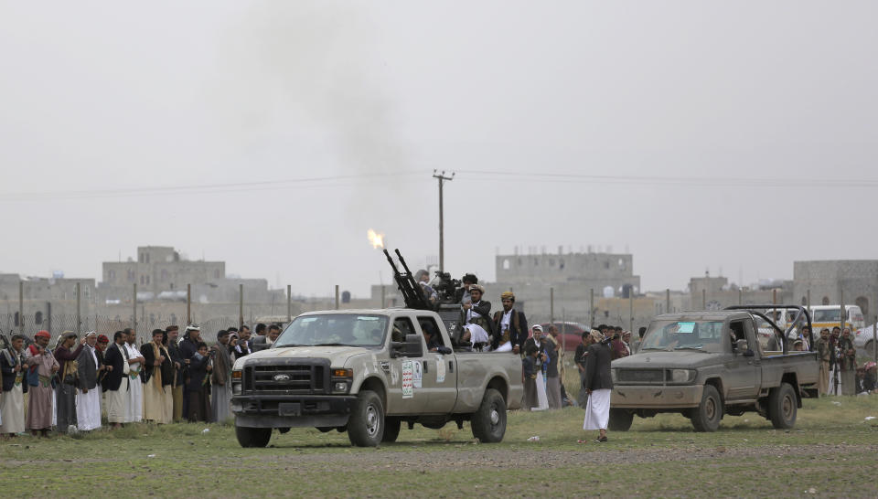 Houthi rebel fighters fire their weapons in the air as they take off to a battlefront following a gathering aimed at mobilizing more fighters for the Houthi movement, in Sanaa, Yemen, Thursday, Aug. 1, 2019. The conflict in Yemen began with the 2014 takeover of Sanaa by the Houthis, who drove out the internationally recognized government. Months later, in March 2015, a Saudi-led coalition launched its air campaign to prevent the rebels from overrunning the country's south. (AP Photo/Hani Mohammed)