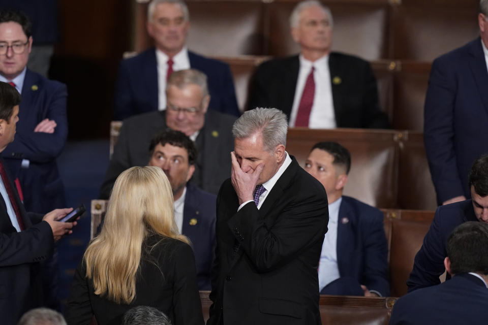 Rep. Kevin McCarthy, R-Calif., talks with Rep. Marjorie Taylor Greene, R-Ga., at the beginning of an evening session after six failed votes to elect a speaker and convene the 118th Congress in Washington, Wednesday, Jan. 4, 2023. (AP Photo/Alex Brandon)