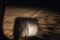 A car drives on a road out of the town of Dakhla in Morocco-administered Western Sahara leading to a remote desert in which smugglers build fishing boats intended to carry migrants to the Canary Islands, Tuesday, Dec. 22, 2020. (AP Photo/Mosa'ab Elshamy)