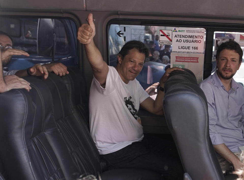 Fernando Haddad, presidential candidate for the Workers' Party, flashes a thumbs up from inside his van as as he campaigns in Rio de Janeiro, Brazil, Tuesday, Oct. 2, 2018. Haddad was hand-picked by Brazil's jailed, former President Luiz Inacio Lula da Silva to be their party's candidate in the Oct. 7 general elections. (AP Photo/Leo Correa)