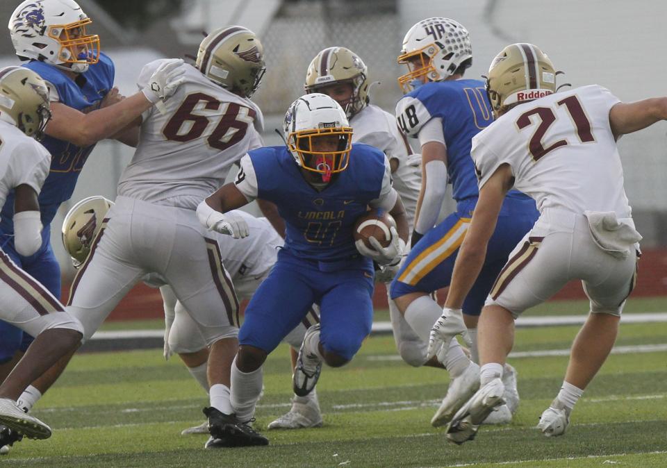 Gahanna Lincoln's Diore Hubbard runs the ball up the field between New Albany's Michael Roth (66) and Tyler Beckman during the Lions' 38-24 win Sept. 30. The teams meet again Nov. 18 in the Division I, Region 3 final.