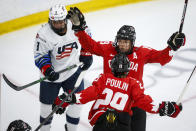 Canada's Brianne Jenner, right rear, celebrates her goal with Marie-Philip Poulin, as United States' Megan Bozek skates away during the second period of the IIHF hockey women's world championships title game in Calgary, Alberta, Tuesday, Aug. 31, 2021. (Jeff McIntosh/The Canadian Press via AP)