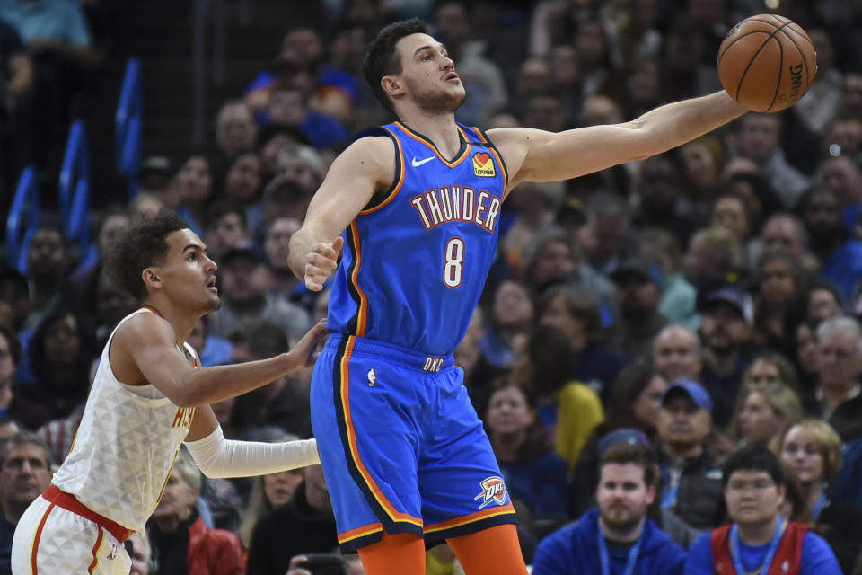 Oklahoma City Thunder forward Danilo Gallinari (8) grabs a pass in front of Atlanta Hawks guard Trae Young, left, in the first half of an NBA basketball game, Friday, Jan. 24, 2020, in Oklahoma City. (AP Photo/Kyle Phillips)