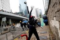 A demonstrator throws an object during a protest in Hong Kong