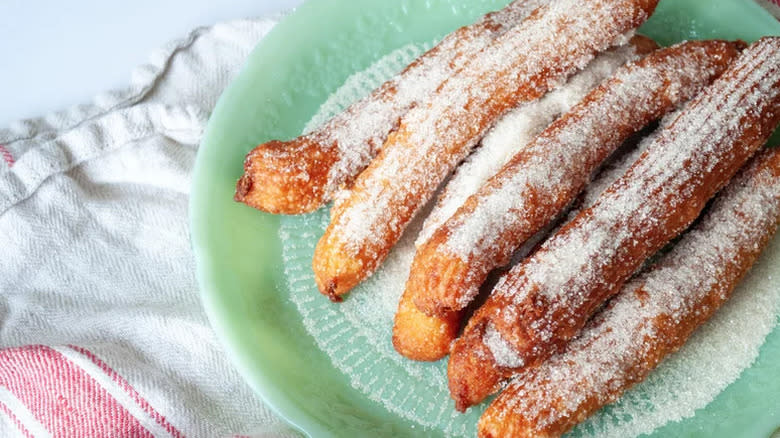 Churros with sugar on plate