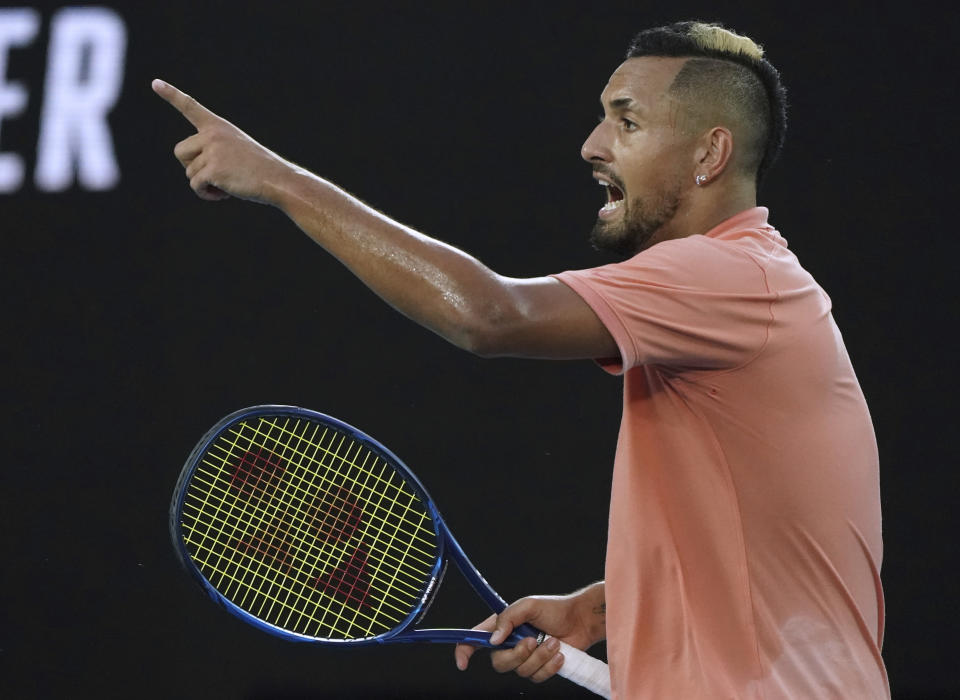 Australia's Nick Kyrgios points with a racket. 