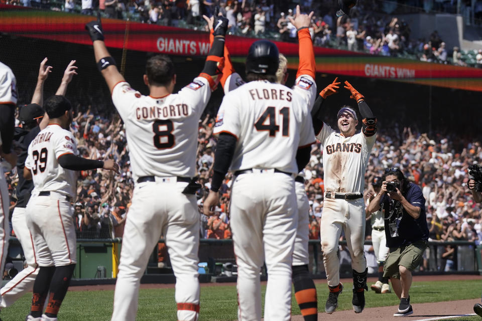 San Francisco Giants' Patrick Bailey, right, celebrates after hitting a two-run home run during the tenth inning of a baseball game against the Texas Rangers in San Francisco, Sunday, Aug. 13, 2023. (AP Photo/Jeff Chiu)