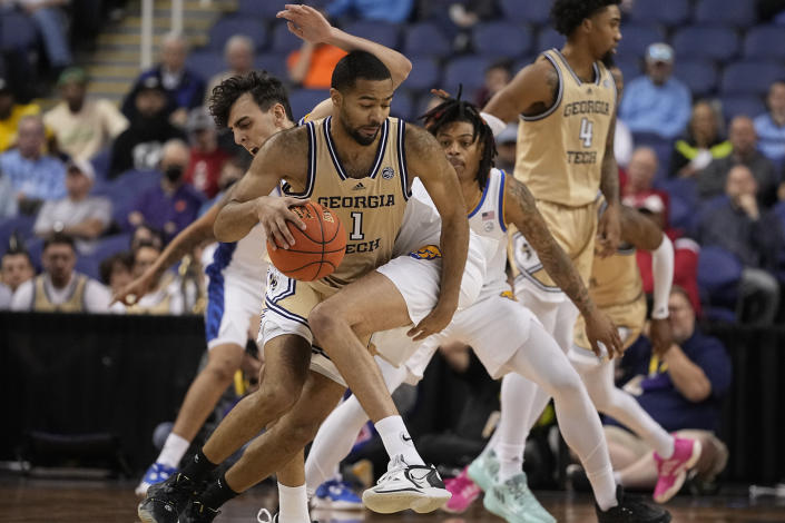 Georgia Tech guard Kyle Sturdivant drives around Pittsburgh forward Guillermo Diaz Graham during the second half of an NCAA college basketball game at the Atlantic Coast Conference Tournament, Wednesday, March 8, 2023, in Greensboro, N.C. (AP Photo/Chris Carlson)