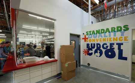 Employees work inside the kitchen of a 365 by Whole Foods Market grocery store ahead of its opening day in Los Angeles, U.S., May 24, 2016. REUTERS/Mario Anzuoni