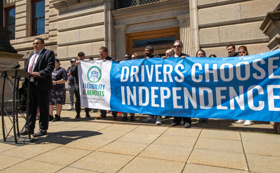 In a file photo, Alex Guardiola speaks during a rally for rideshare drivers at City Hall.