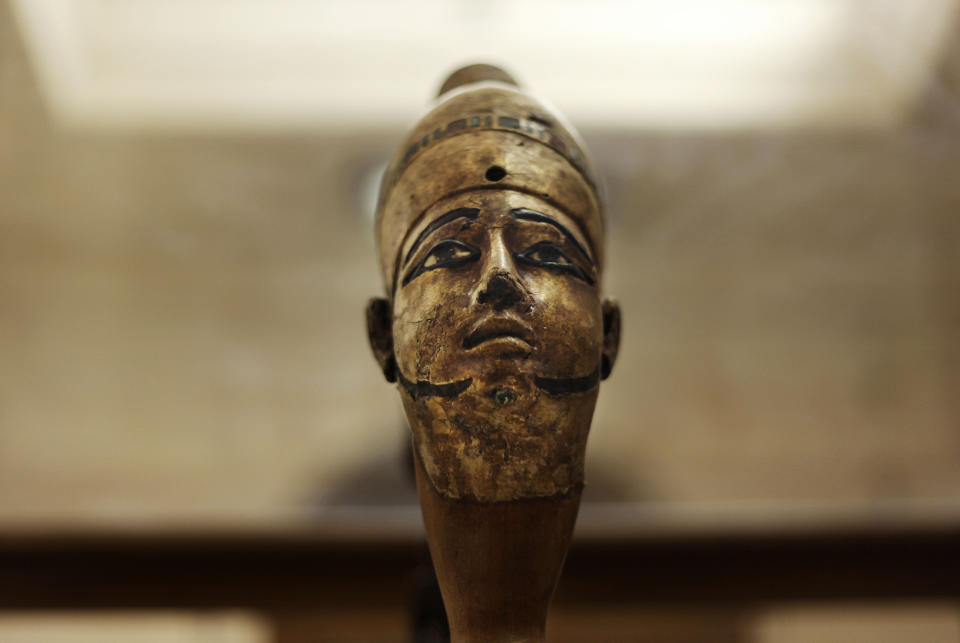 In this Wednesday, Oct. 30, 2013 photo, an ancient Egyptian statue is seen on display inside its glass case in the Egyptian Museum near Tahrir Square in Cairo, Egypt. The 111-year-old museum, a treasure trove of pharaonic antiquities, has long been one of the centerpieces of tourism to Egypt. But the constant instability since the 2011 uprising that toppled autocrat Hosni Mubarak has dried up tourism to the country, slashing a key source of revenue. Moreover, political backbiting and attempts to stop corruption have had a knock-on effect of bringing a de facto ban on sending antiquities on tours to museums abroad, cutting off what was once a major source of funding for the museum. (AP Photo/Nariman El-Mofty)