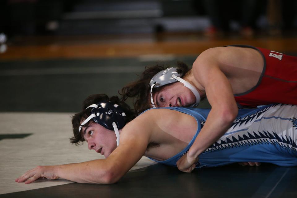 From left, Saugerties' James Burns and Red Hook's Christian Totman wrestle in the 172-pound match during the Section 9 Duals Division II final at Minisink Valley High School on January 11, 2023.