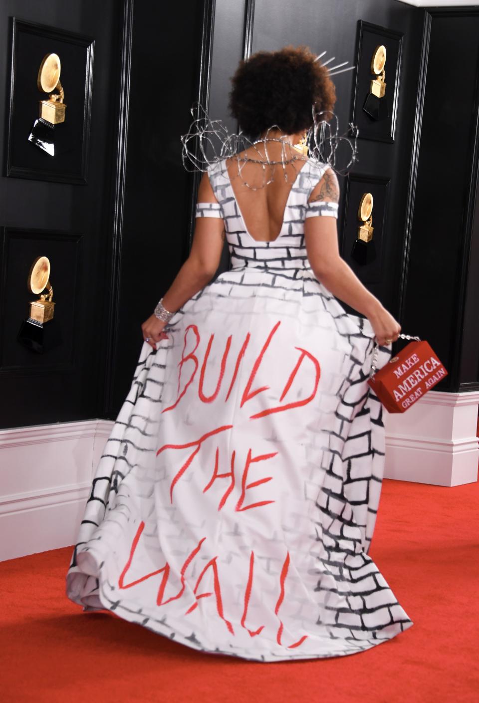 However, she removed the outer layer and revealed a white dress with a brick wall motif painted on it and “Build the Wall” in red graffiti on the back. Photo: Getty Images