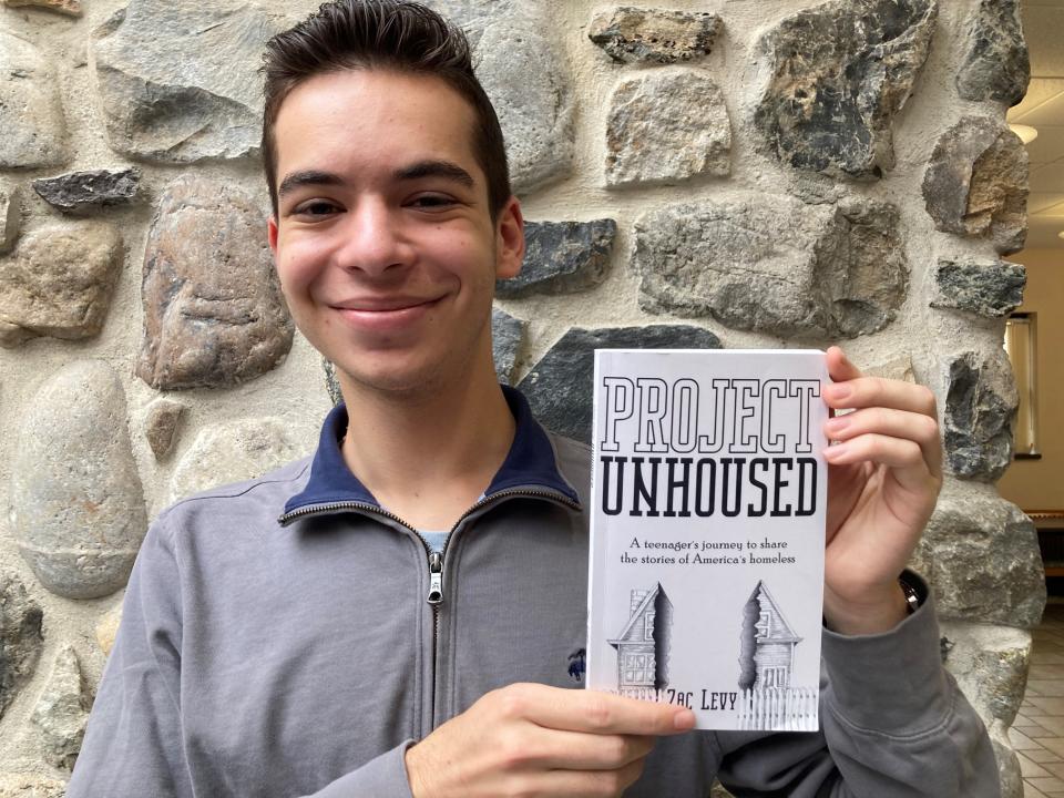 Zac Levy with his book, "Project Unhoused."