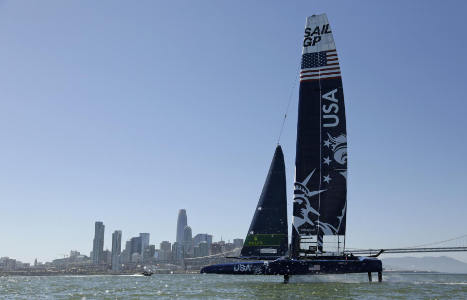 The U.S. team F50 foiling catamaran trains with the skyline in the distance after its launch Monday, April 22, 2019, in San Francisco. New global sports league SailGP launched the first of six F50 race boats into San Francisco Bay that will compete May 4-5. The catamaran is capable of hitting speeds of 60 miles per hour. (AP Photo/Eric Risberg)