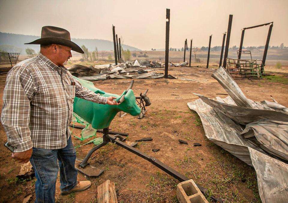 Standing in the burned-out wreckage of his barn on May 12, 2022, John Martinez of Las Vegas, who has a 16-acre spread in Manuelitas, N.M., talks about the capricious fire that left his house untouched but destroyed a $3,000 roping horse just hours after he and his wife evacuated.