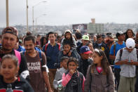 <p>Members of a caravan of migrants from Central America walk towards the United States border and customs facility, where they are expected to apply for asylum, in Tijuana, Mexico April 29, 2018. (Photo: Edgard Garrido/Reuters) </p>