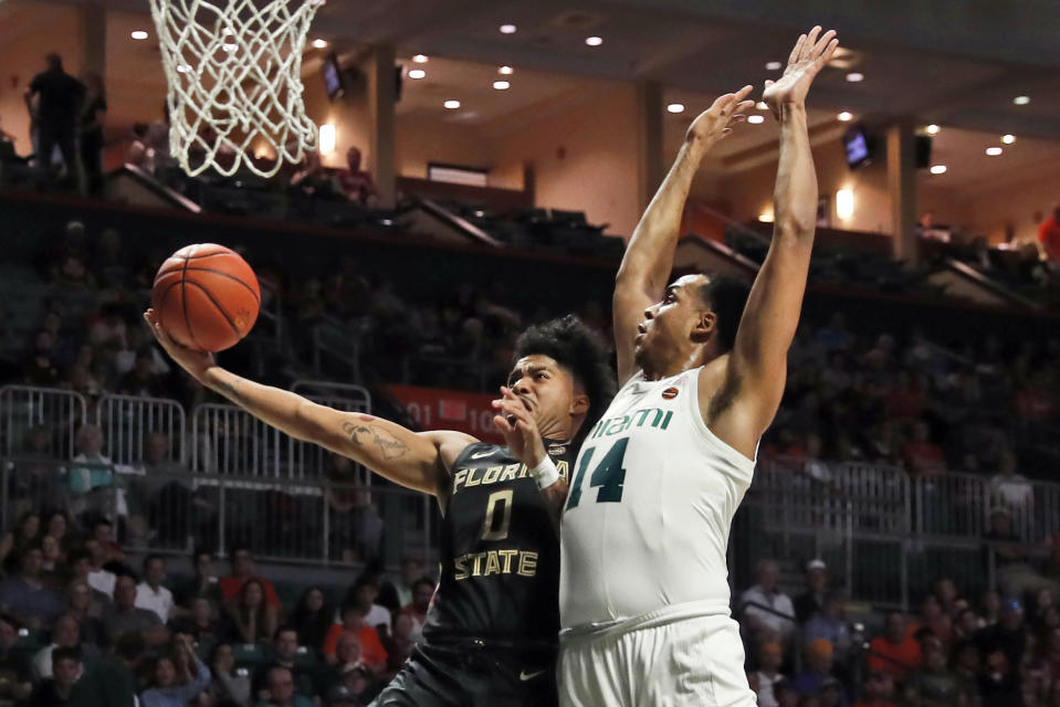 Florida State guard Rayquan Evans (0) shoots the ball against Miami center Rodney Miller Jr. (14) during the first half of an NCAA college basketball game on Saturday, Jan. 18, 2020, in Coral Gables, Fla. (AP Photo/Brynn Anderson)