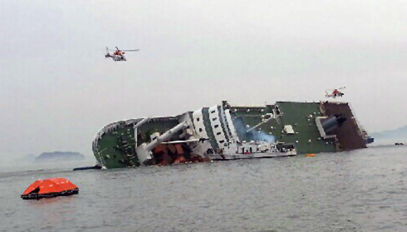 South Korean rescue helicopters fly over a South Korean passenger ship, trying to rescue passengers from the ship in water off the southern coast in South Korea, Wednesday, April 16, 2014. A government office said the passenger ship carrying about 470 people have sent a distress call off the southern coast after it began tittering to one side. (AP Photo/Yonhap) KOREA OUT
