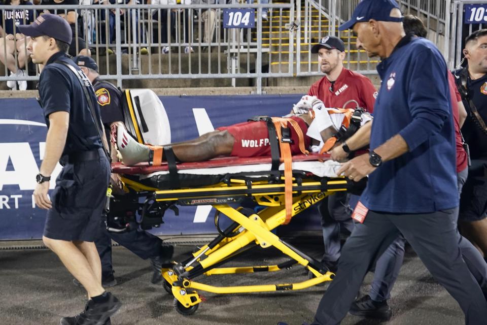 North Carolina State's Rakeim Ashford is carted off of the field after being injured in the third quarter of an NCAA college football game against UConn in East Hartford, Conn., Thursday, Aug. 31, 2023. (AP Photo/Bryan Woolston)