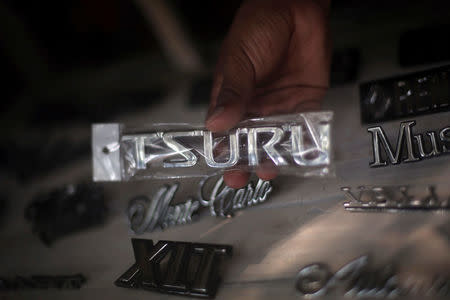 A seller shows a logo of Nissan Tsuru, in Mexico City, Mexico, October 26, 2016. REUTERS/Edgard Garrido