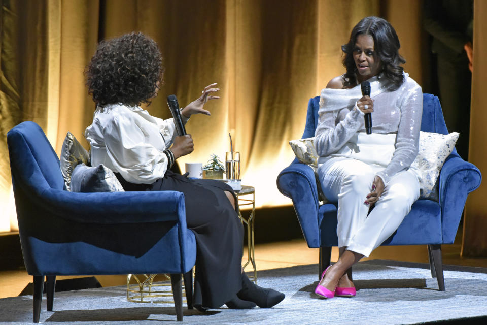 Michelle Obama, right, discusses her new book with Oprah Winfrey during an intimate conversation to promote "Becoming" at the United Center on Tuesday, Nov. 13, 2018, in Chicago. (Photo by Rob Grabowski/Invision/AP)