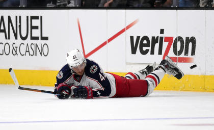 Columbus Blue Jackets center Artem Anisimov, of Russia, dives for the puck during the third period of an NHL hockey game, Sunday, Oct. 26, 2014, in Los Angeles. The Kings won 5-2. (AP Photo/Mark J. Terrill)