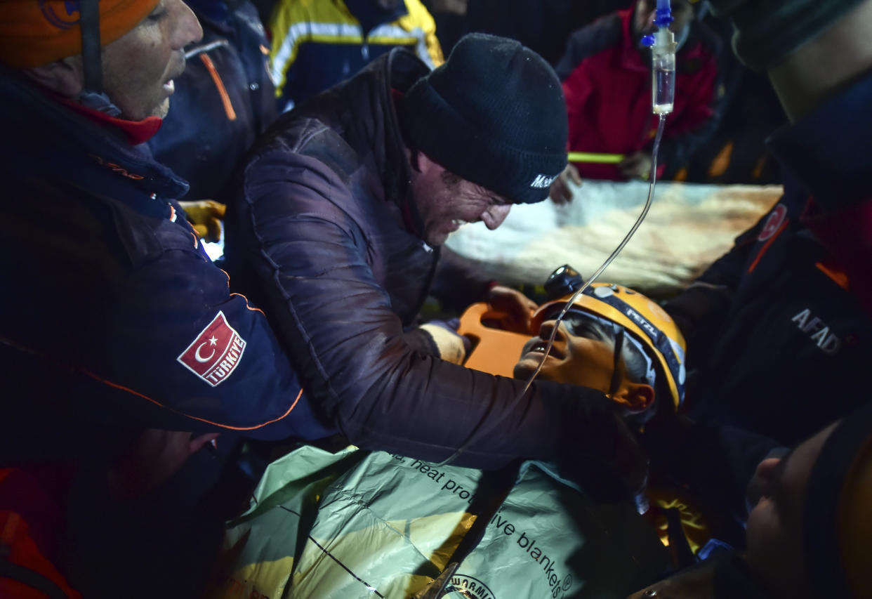 Turkish rescue workers carry Kamil Can Agdas to an ambulance after pulled him out from a collapsed building five days after the earthquake, in Kahramanmaras, southern Turkey, early Saturday, Feb. 11, 2023. (Ismail Coskun/IHA via AP Photo)