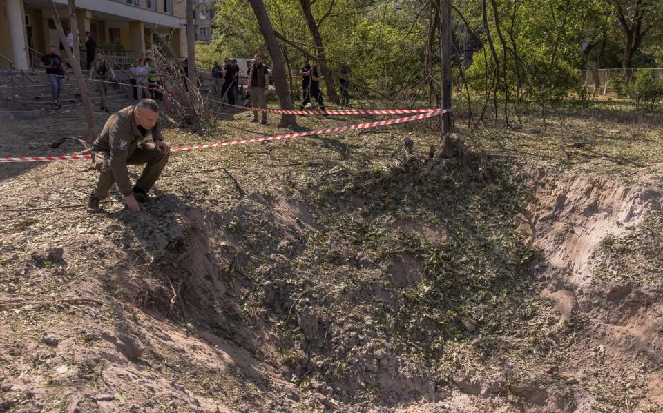 Kyiv mayor Vitali Klitschko looks at a crater outside a clinic following a Russian missile attack - Roman Pilipey/Getty Images Europe