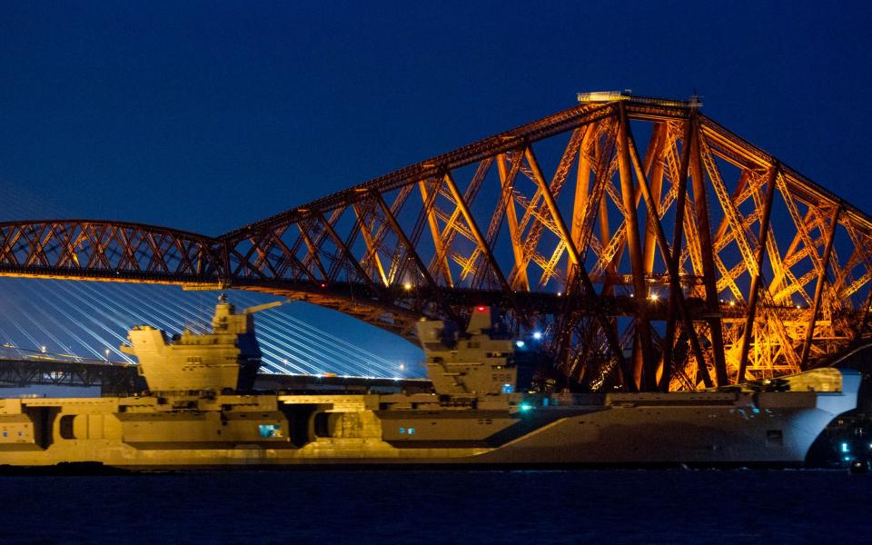 HMS Queen Elizabeth squeezes under the Forth Rail Bridge - Credit: SWNS.com