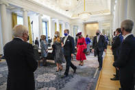 Heir to the Dutch throne Princess Amalia, center left, is escorted by her father King Willem-Alexander after she took an honorary seat at the Council of State, the highest government advisory body in The Hague, Netherlands, Wednesday, Dec. 8, 2021, one day after celebrating her eighteenth birthday. Queen Maxima, center in red, minister of State Tjeenk Willink, left, and vice-president Thom de Graaf, center right. (AP Photo/Peter Dejong, Pool)